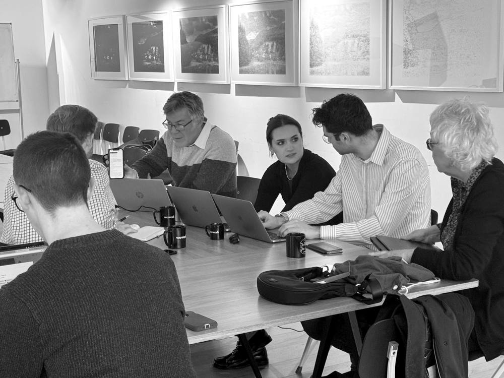 A team working at laptops during a hands-on AI build session